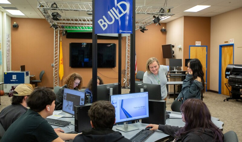 Students at the Northpoint STEAM lab collaborate on a design project under a 'BUILD' sign with guidance from their teacher.
